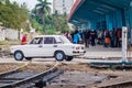 CAMAGUEY, CUBA - JAN 25, 2016: Soviet Lada car is crossing the railway tracks in Camague Royalty Free Stock Photo