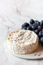 Camambert french soft cheese served with grapes, decorated with thyme branches Royalty Free Stock Photo