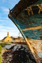 Historic chapel and fishing boat wrecks in the harbor of Camaret-sur-Mer in Brittany