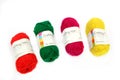 Camberley, UK - Feb 22nd 2017: Four balls of colourful red, green, yellow and pink wool or yarn on a white background