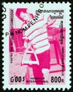 CAMBODIA - CIRCA 1996: A stamp printed in Cambodia shows man making crutches, circa 1996.