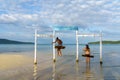 Cambodia. Koh Rong Samloem Island, young girls playing on a swing