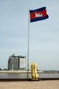 Cambodia National flag and lion statue next to.