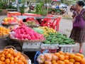 Cambodia, Siem Reap 12/08/2018 Elderly Asian woman chooses fruit in the bazaar