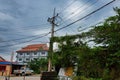 Cambodia, Siem Reap 12/08/2018 green thickets on the streets of the city, a pole of power lines in slums, urban jungle
