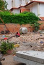 Man in a red shirt sitting on a pile of construction waste