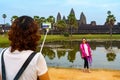 Cambodia. Siem Reap Province. Tourists photographing themselves in front of the templef at Angkor Wat Temple