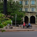 Scooters and cyclist drive past the hotel, Southeast Asia