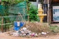 Cambodia, Siem Reap 12/08/2018 a small Buddhist sanctuary among the heaps of garbage on a city street, a garbage dump near a