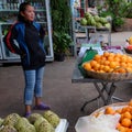 Young Asian girl sells fruit on a city street