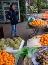 Young Asian girl sells fruit on a city street