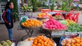 Young Asian girl sells fruit on a city street