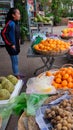 Young Asian girl sells fruit on a city street