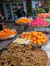 Young Asian girl sells fruit on a city street