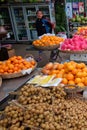 Young Asian girl sells fruit on a city street