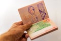 Cambodia visa stamp at russian passport in mens hand Royalty Free Stock Photo