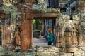 Cambodia. A woman cleans the old ruins of Banteay Kdei Temple