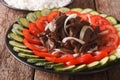 Cambodian beef Lok Lak with fresh vegetables close-up. Horizontal