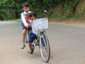 Cambodian children going to school by bycicle Royalty Free Stock Photo