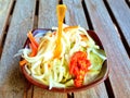 Cambodian food - white radish, green papaya cucumber and chilis pickle in small bowl on wooden table for eat with main khmer food Royalty Free Stock Photo