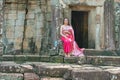 Cambodian girl at the entrance to Bayon temple in Angkor Thom, C