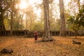 Happy Smiling Cambodian Asian Girl in Traditional Dress at Ancient Temple Ruins in Angkor Thom Old Tree Royalty Free Stock Photo