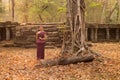 Happy Smiling Cambodian Asian Girl in Traditional Dress at Ancient Temple Ruins in Angkor Thom Old Tree Royalty Free Stock Photo