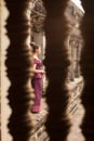 Cambodian Asian Girl in Traditional Dress Through a Window at Angkor Wat Temple Royalty Free Stock Photo