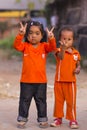 Cambodian girls in Muslim district of the town show their finger