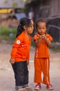Cambodian girls in Muslim district of the town show their finger