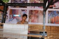 A cambodian lady is weavering silk scarves.