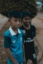 Cambodian local boys standing at the street and looking into camera