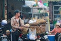 Cambodian male street vendor of boiled beans and jicama yam bean fruit standing beside the street for sell in the fresh market