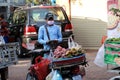 Cambodian male street vendor of boiled sweet potatoes and boiled taro with other kinds of dessert standing beside the street for