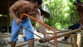 Cambodian man cut wood to build home construction