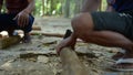 Cambodian man using axe to incise wooden beam