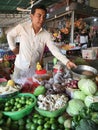 An unidentified man sells vegetables at a local market