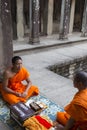 Cambodian monks sitting on stairs at Angkor Wat temple, Cambodia Royalty Free Stock Photo