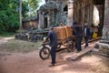 Cambodian people carrying a giant sandstone during the renovation of th Preah Khan Temple site in Cambodia