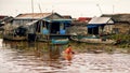Cambodian people live on Tonle Sap Lake in Siem Reap, Cambodia. Cambodian boys use basin as a boat