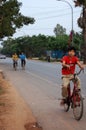 Cambodian people riding motorcycle and driving vehicle car and biking bicycle on street with traffic angkor wat road go to work at