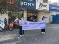 Cambodian Red Cross CRC young female volunteers holding a flag promote health care