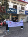 Cambodian Red Cross CRC young female volunteers holding a flag promote health care