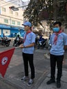 Cambodian Red Cross CRC young male volunteers holding a flag promote health care on the street