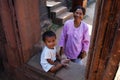 Cambodian senior old women and cambodia children boy people travel visit respect praying Angkor wat temple ancient ruins castle at Royalty Free Stock Photo