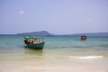 Cambodian traditional fishing boat near Koh Rohn island seashore. Green and red wooden boat. Royalty Free Stock Photo