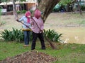 Cambodian women cleaning the street