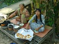 Cambodian women making and selling cakes
