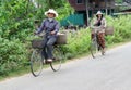 Cambodian women ride bycicle