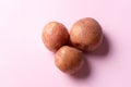 Cambray potatoes on pink background Royalty Free Stock Photo